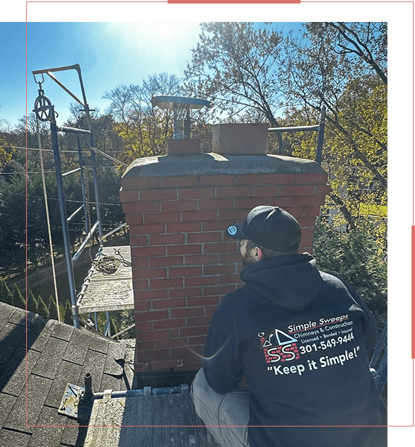 Worker inspecting a brick chimney on a rooftop under clear skies.